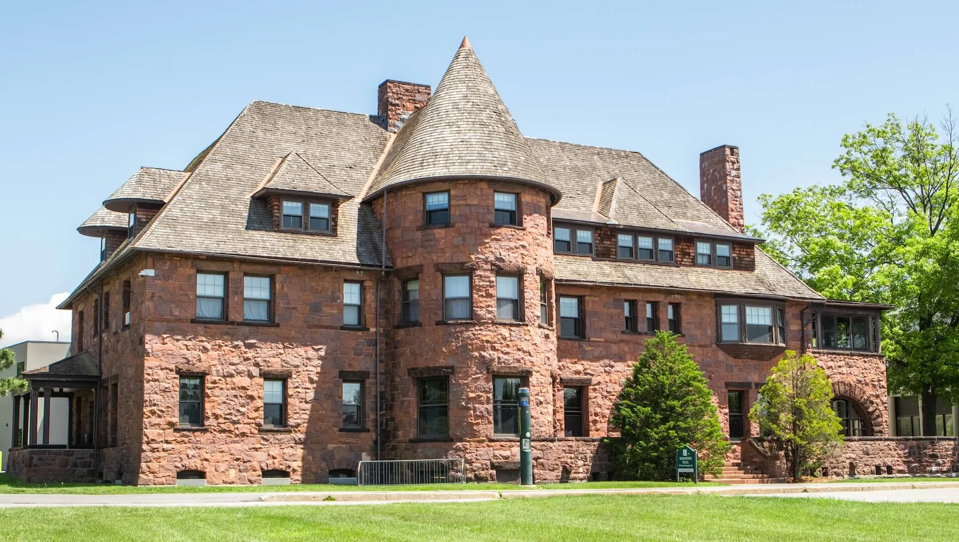A historic brick building with a round turret.