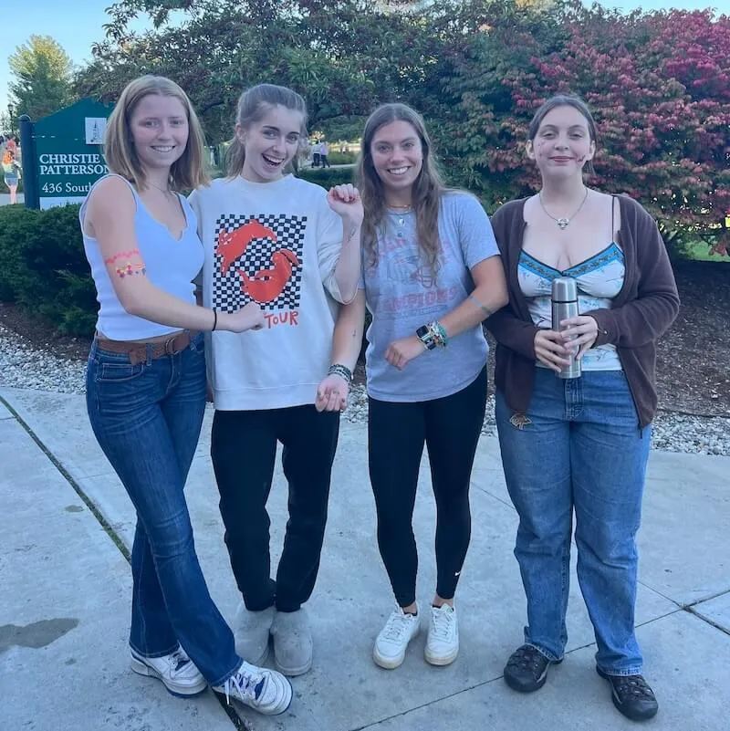 Students showing off face and arm paint. 