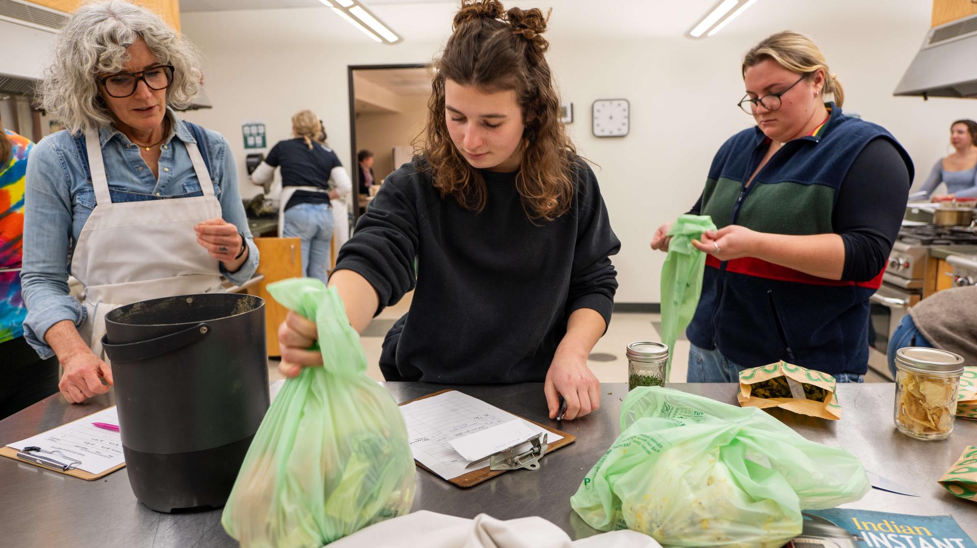 Researchers weighing bags of food waste