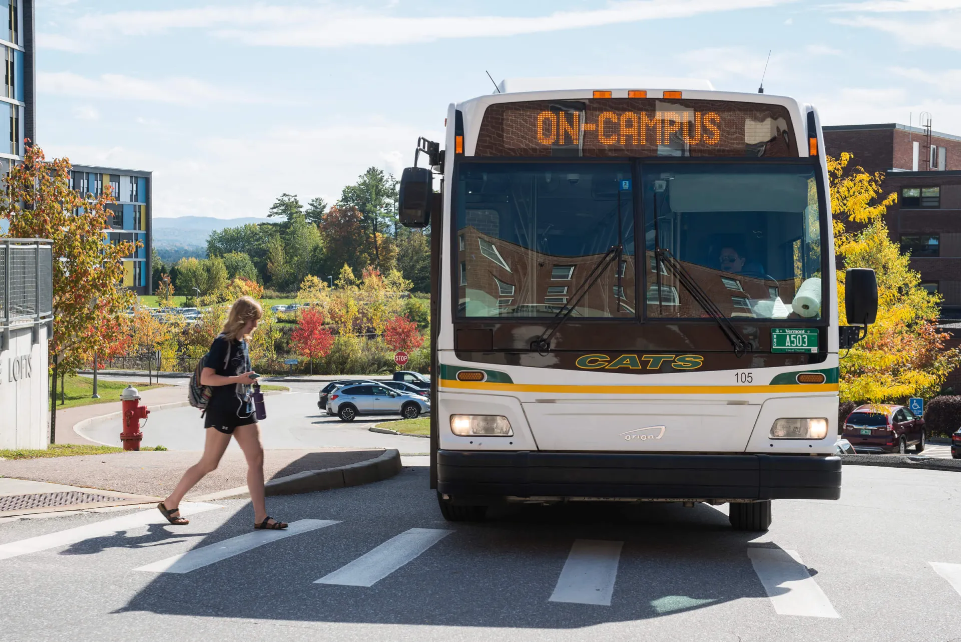 Student boarding the UVM bus on Redstone Campus.