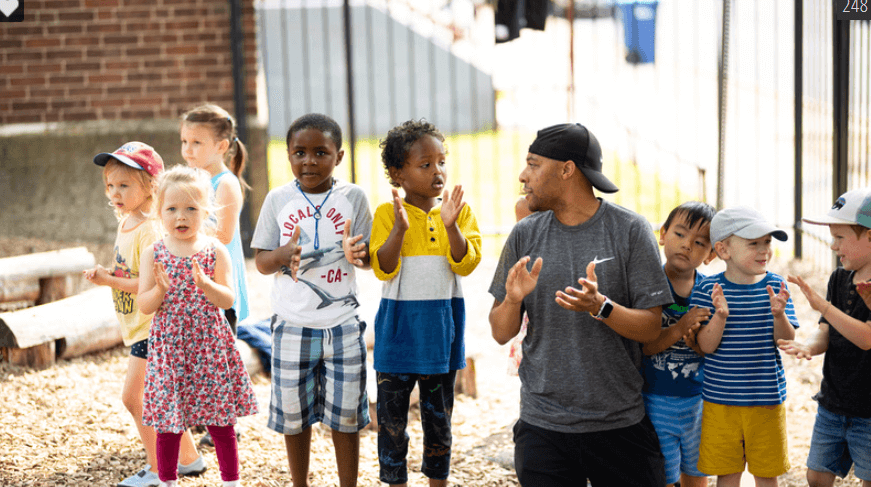 School children playing outside with an adult