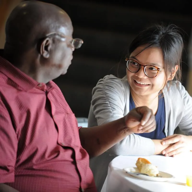older person and younger person having a conversation
