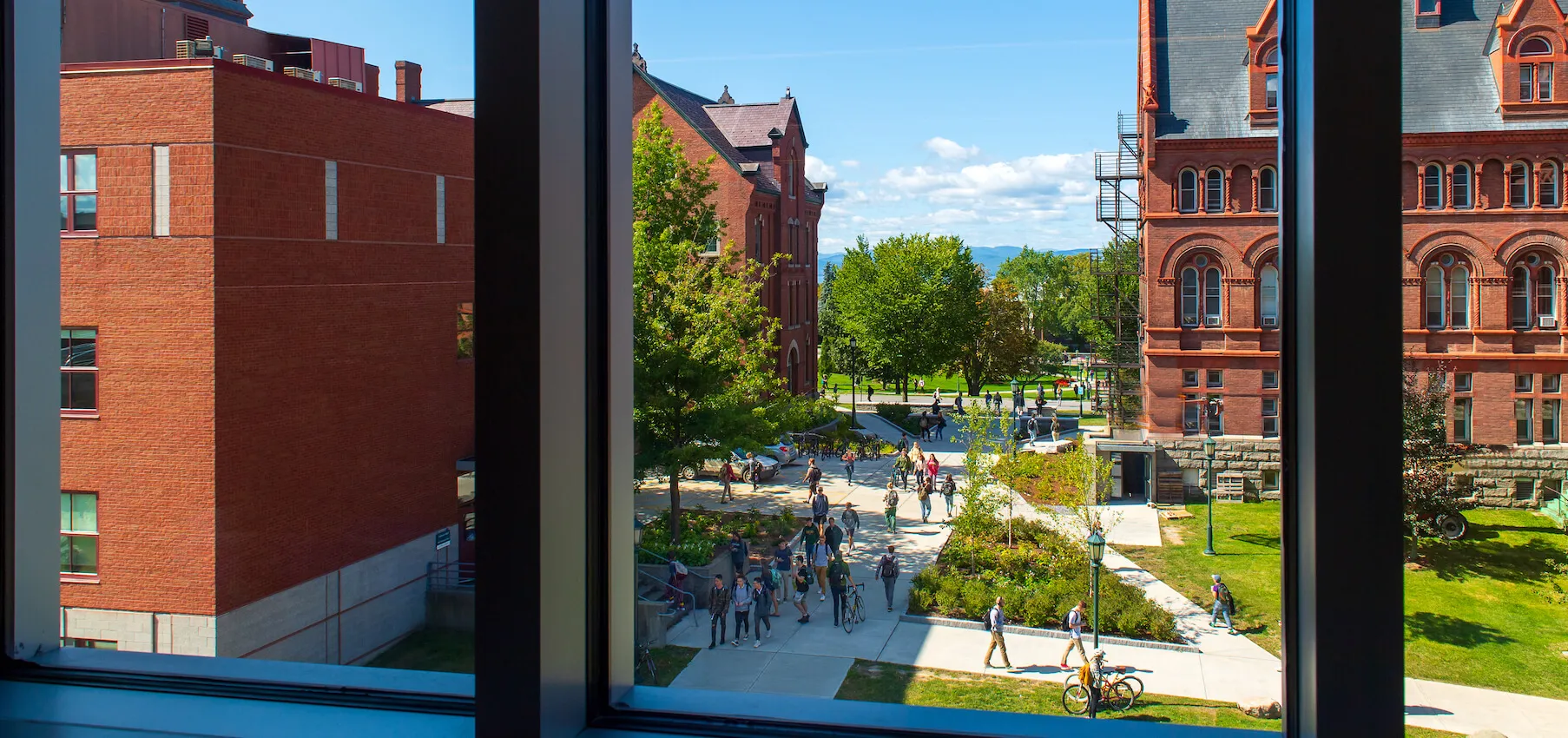 Looking out of a window to see students walking between classes on central campus.