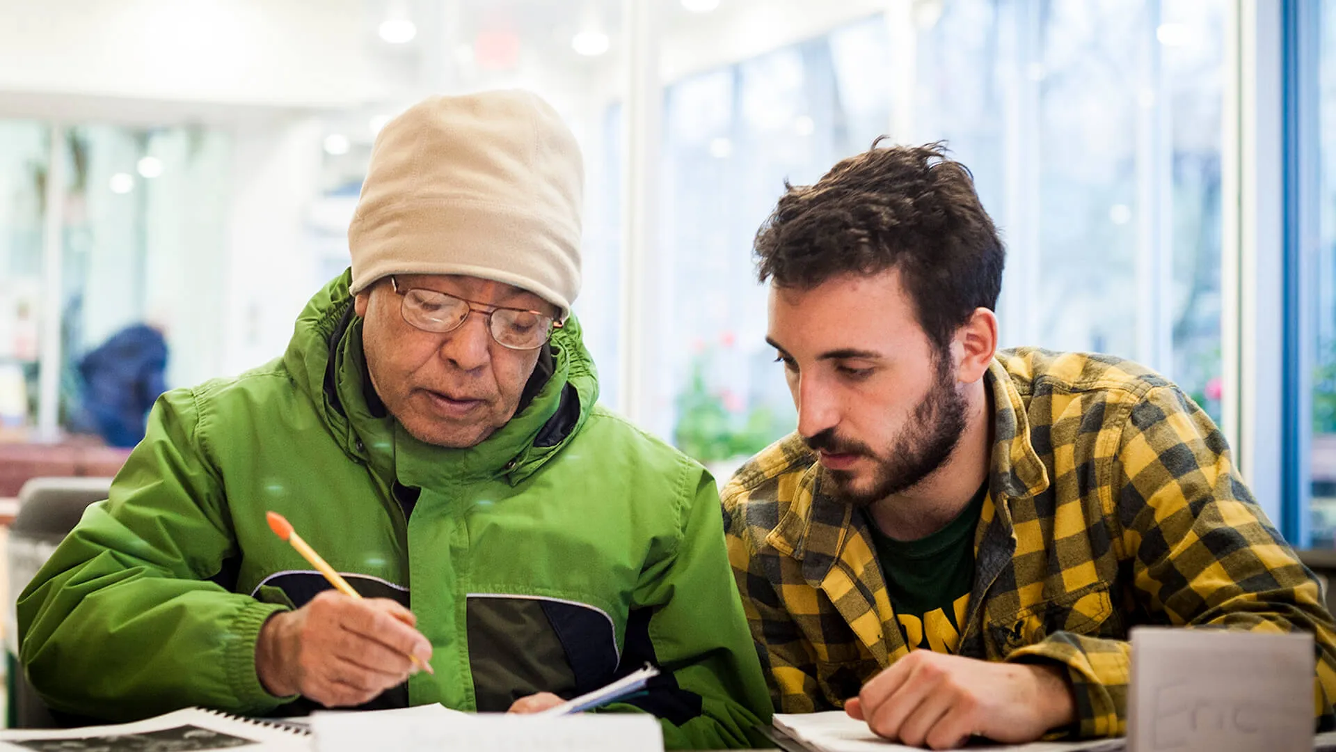 Student helping a new American through service-learning in the local community.