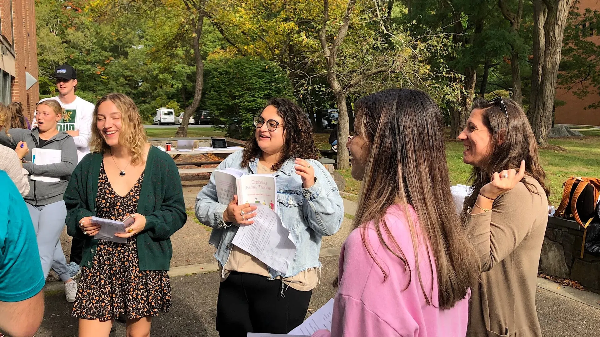 HDFS students laughing as they work together on a group project outside.