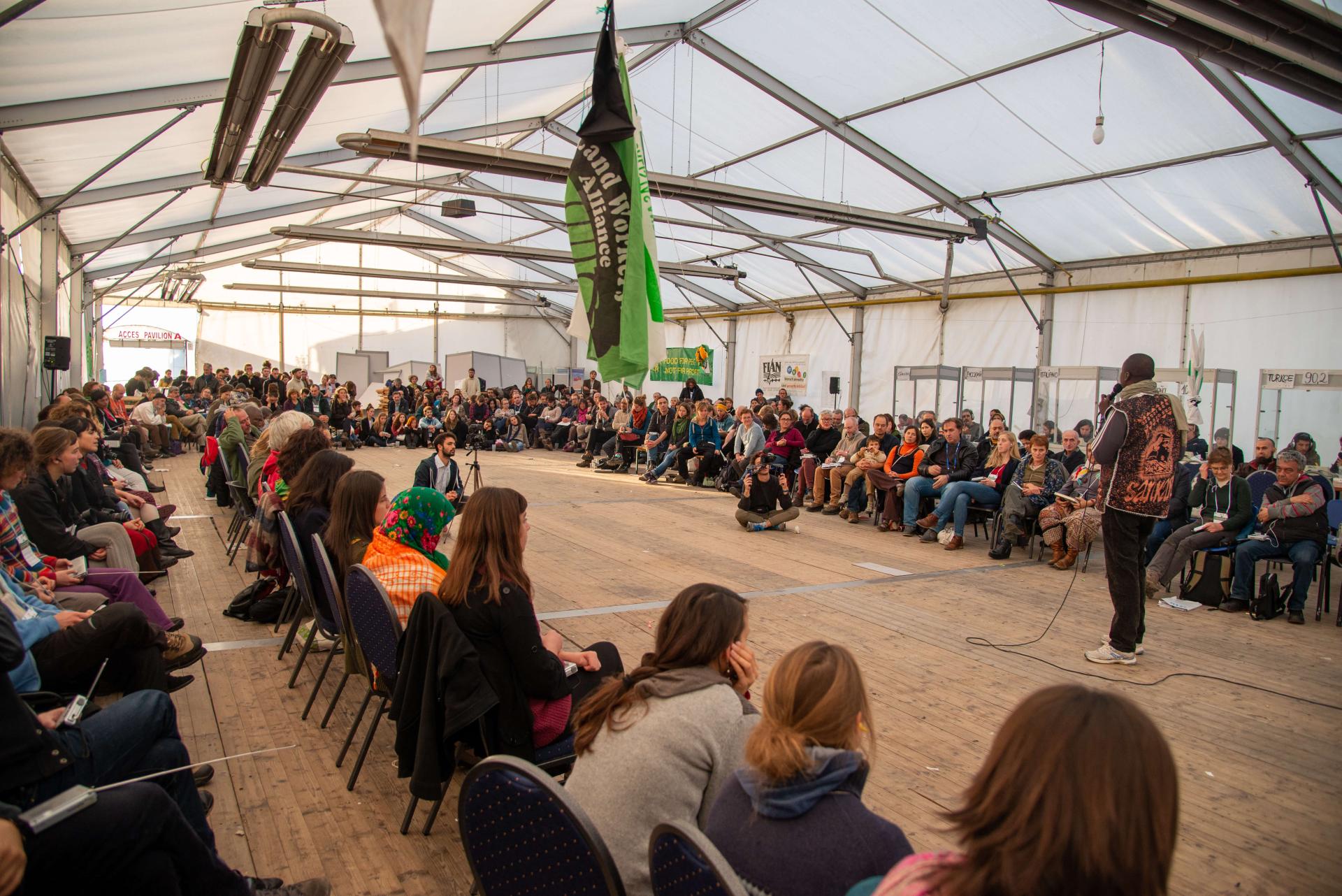 Nyeleni International meeting in a large indoor space, full of people