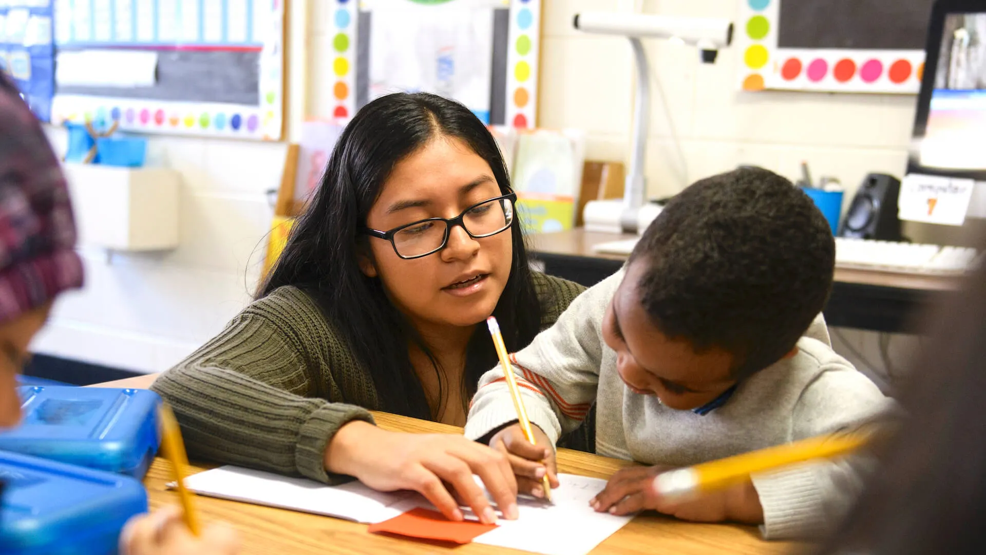 Student teacher working with student in school internship.