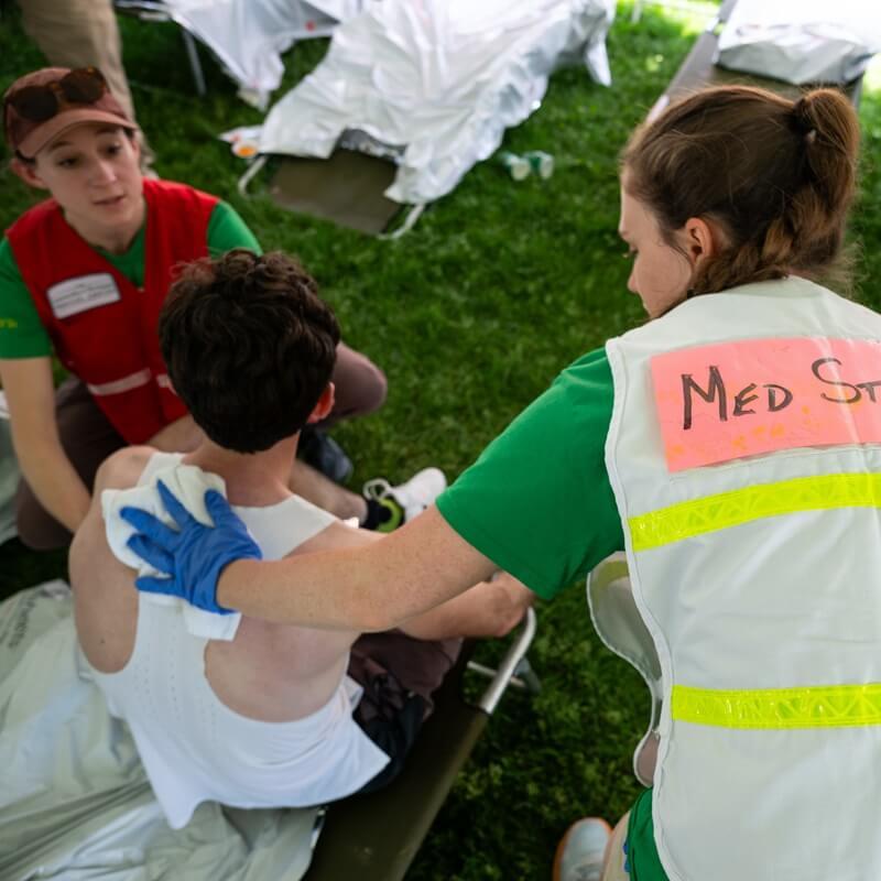 Larner students tend an injured runner in medical tent