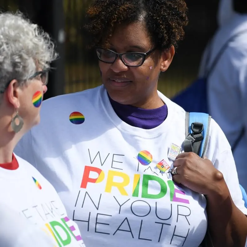 staff chatting at community pride event