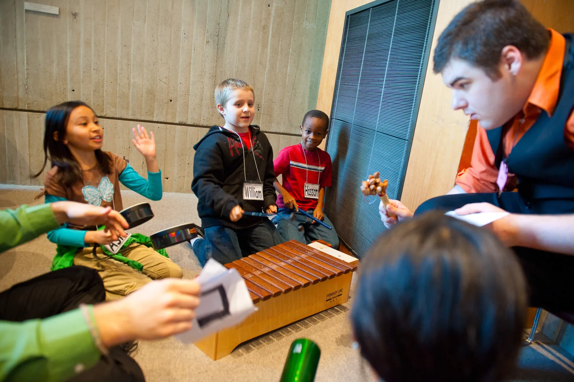 Music teacher leads a group of students at local school.