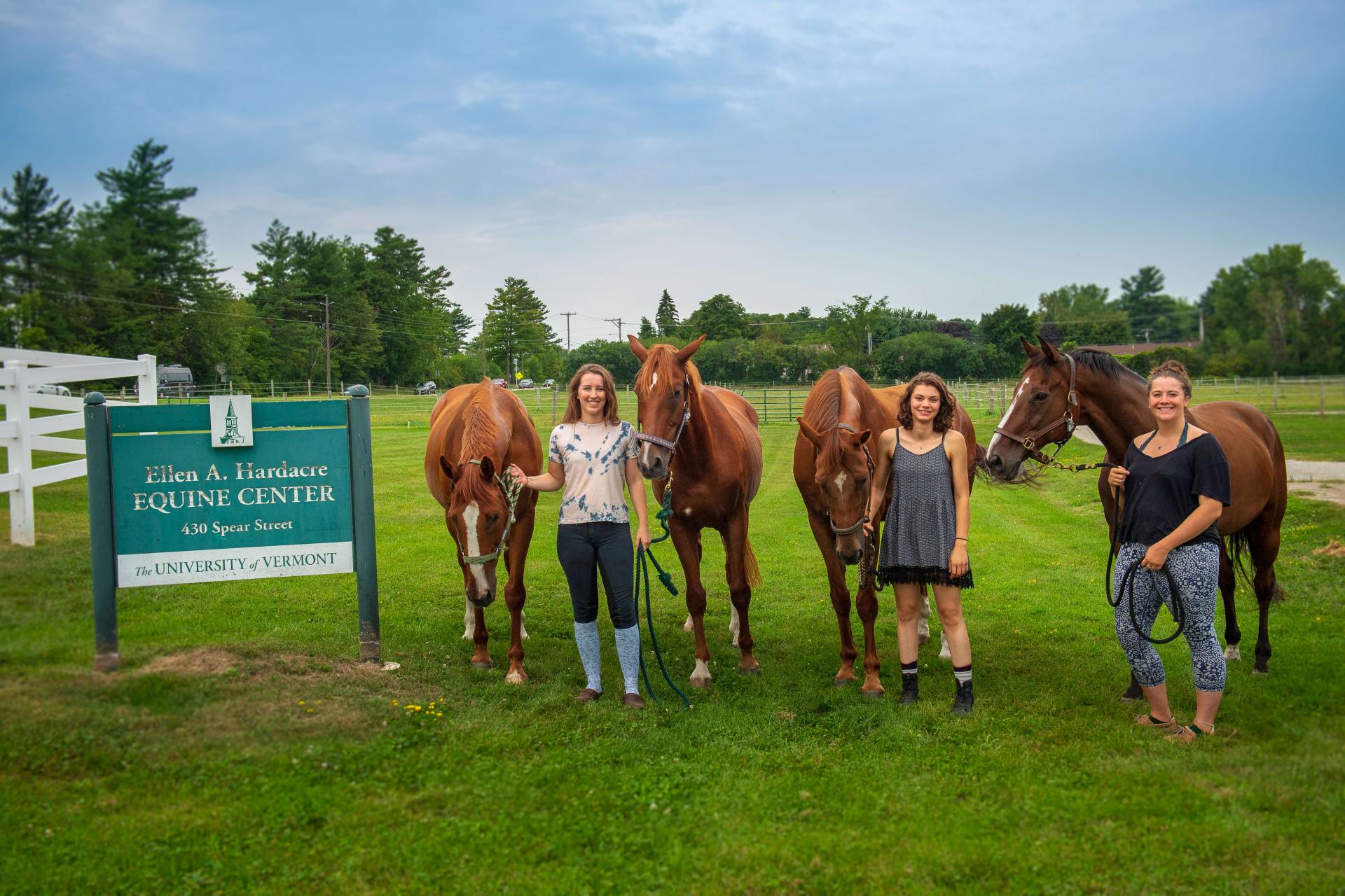 three students with their horses