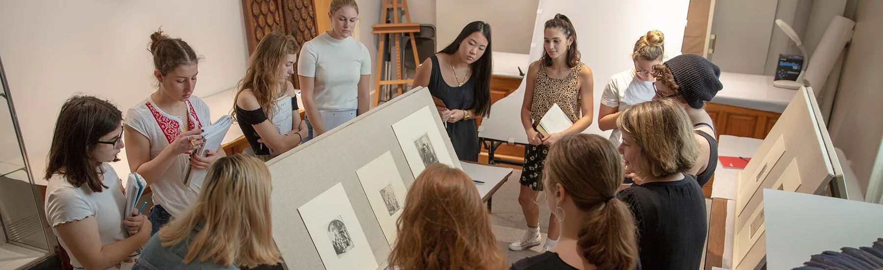 Group of student examining and studying old art