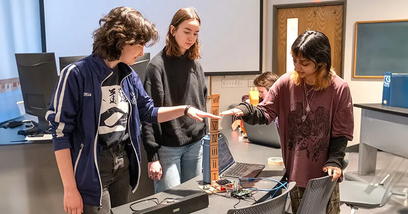 A team of CS students demonstrate their project using a Raspberry Pi