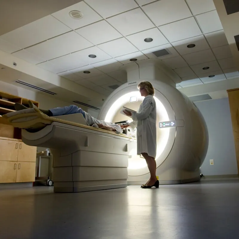 Doctor standing beside MRI machine