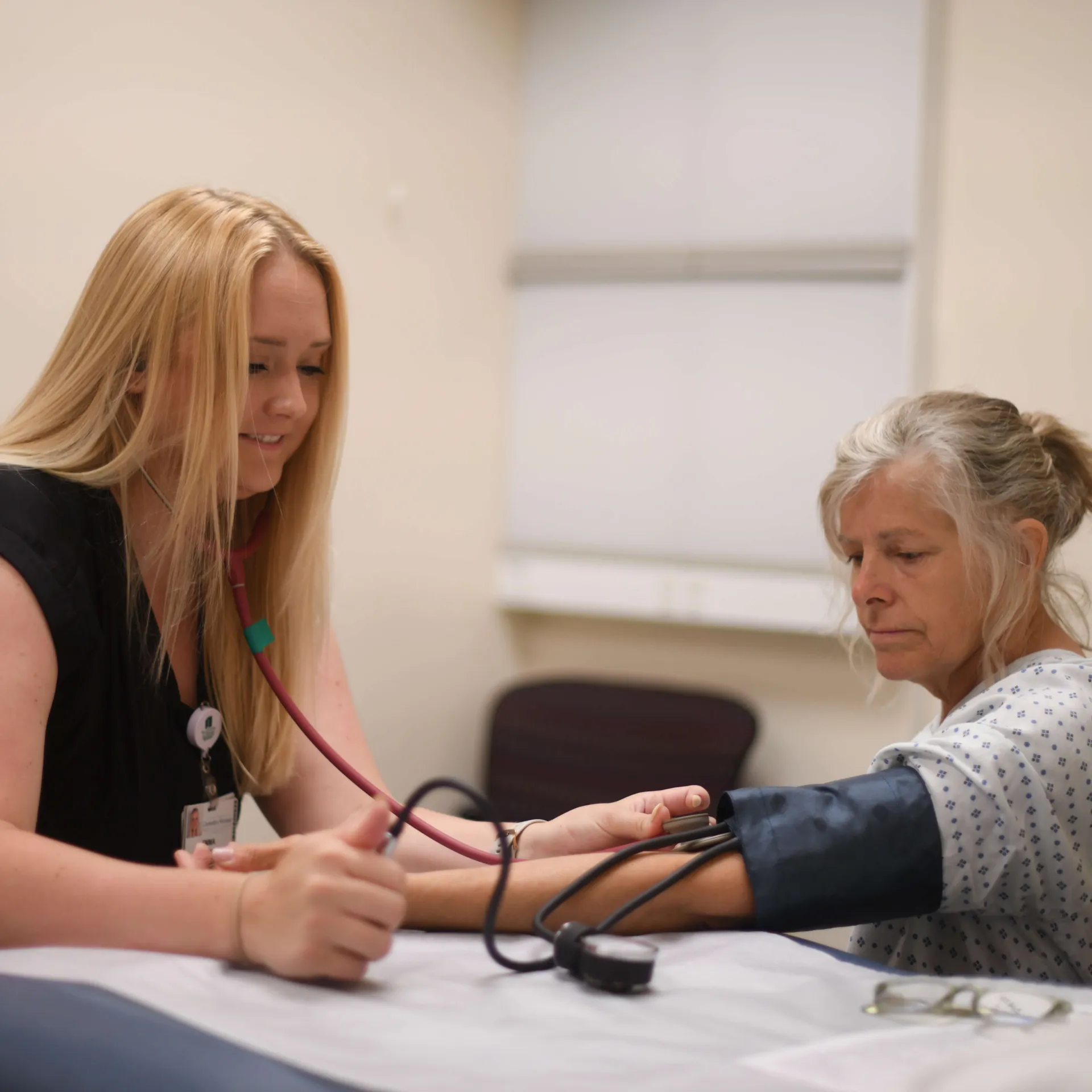A physician performing a blood pressure test on a patient.