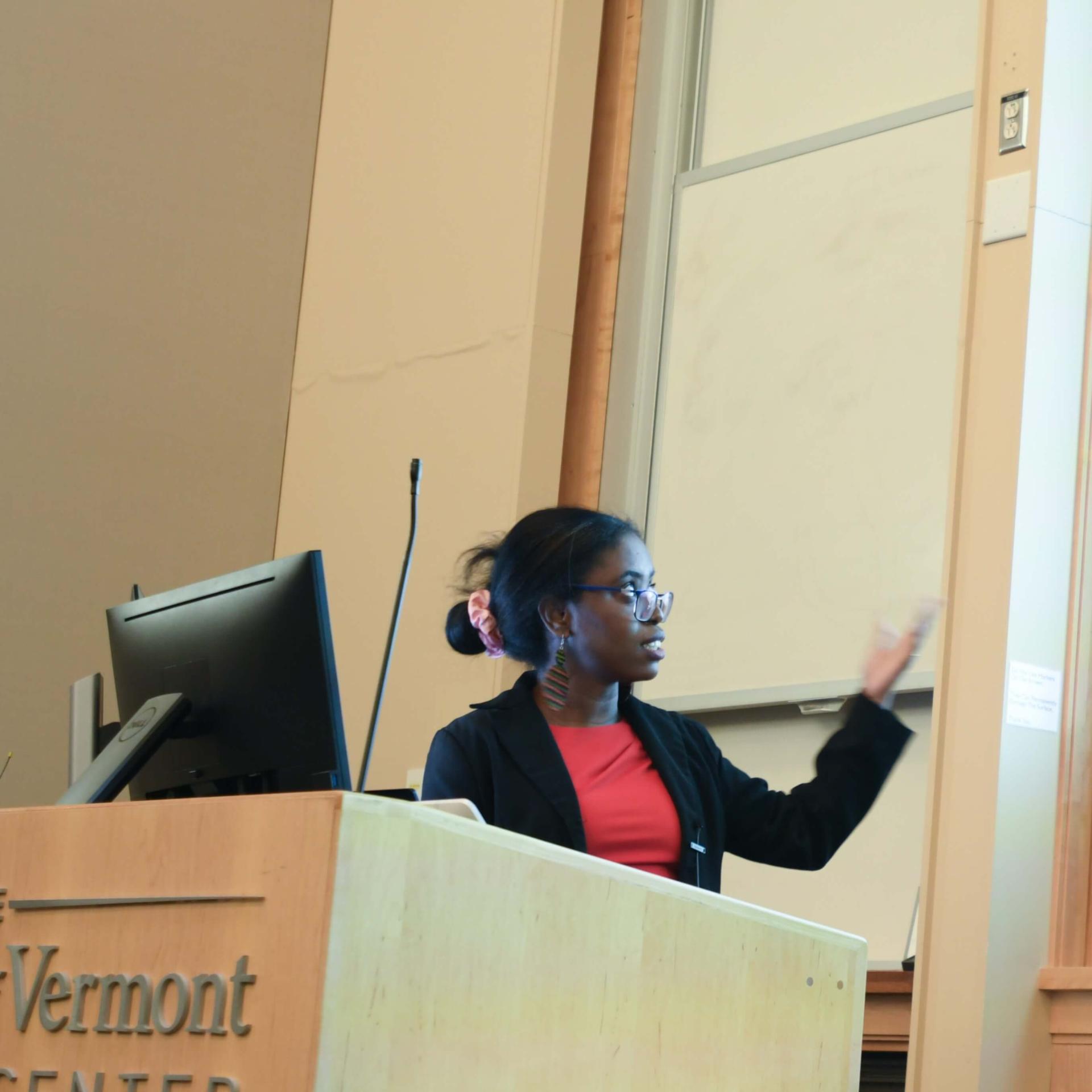 A student presenting her research findings at a symposium.