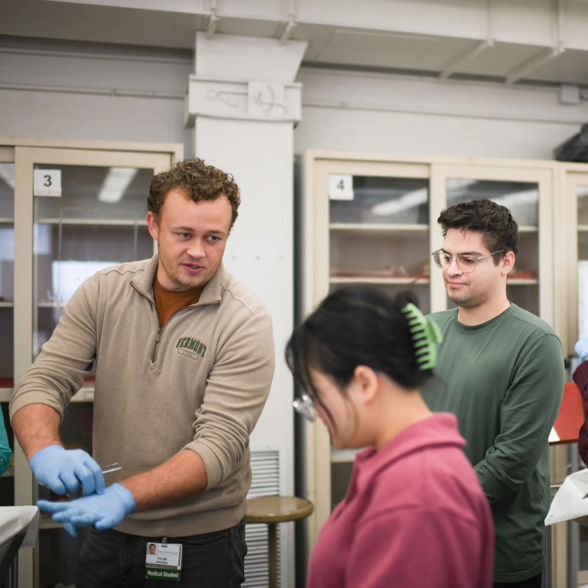 A lab instructor talking to a group of medical students. 
