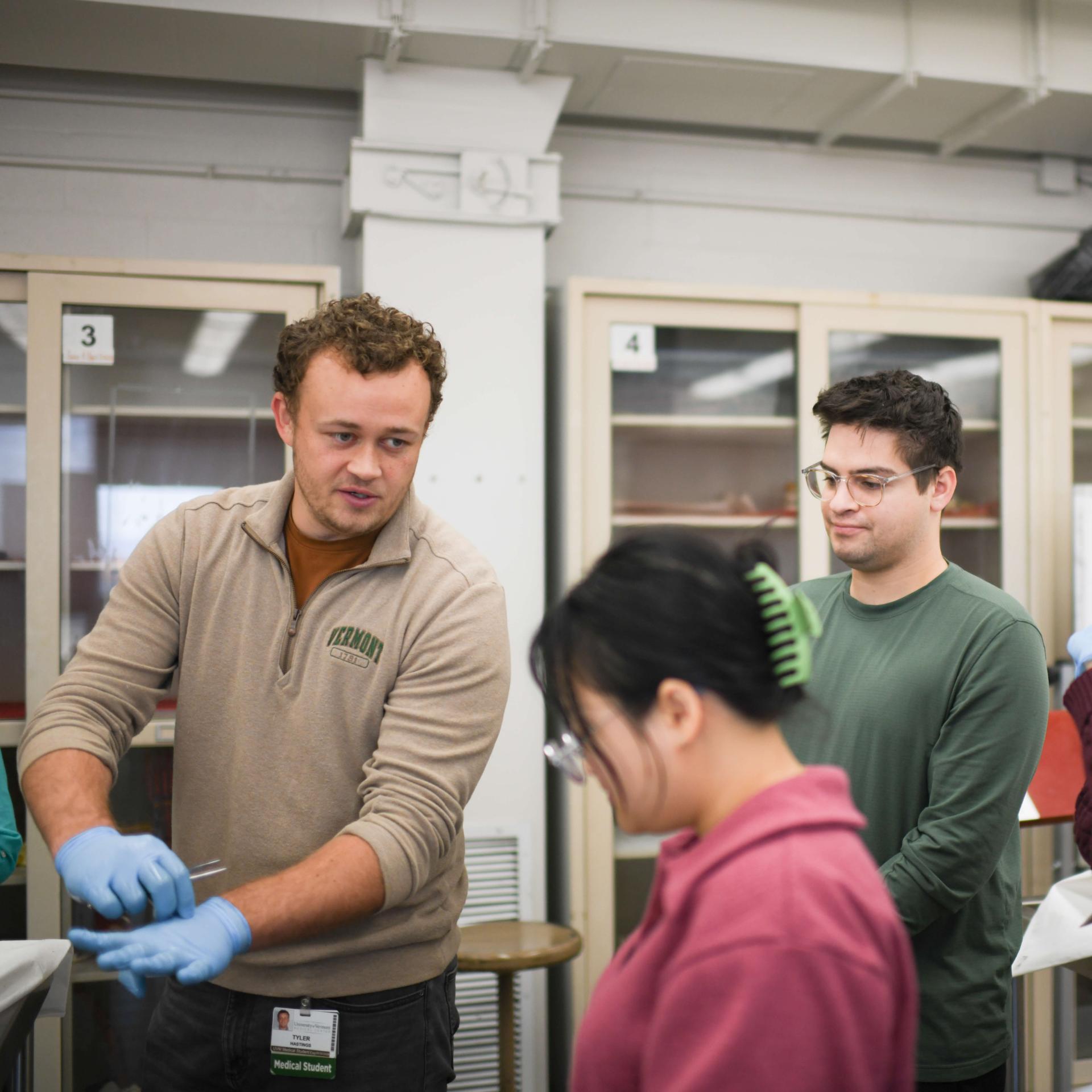 A lab instructor talking to a group of medical students.