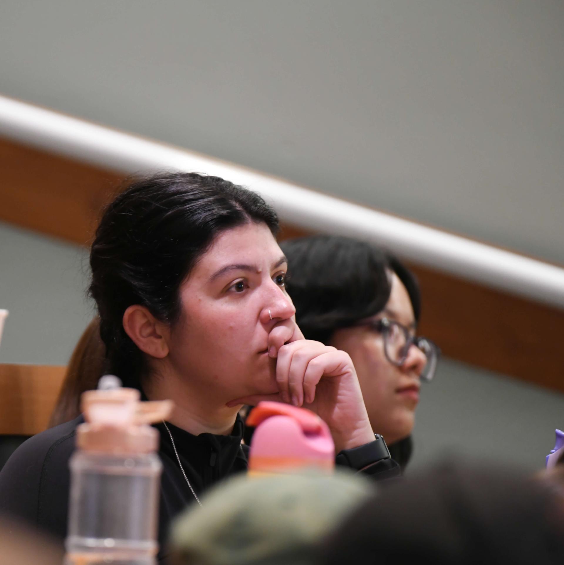 A student intently listening to a lecture