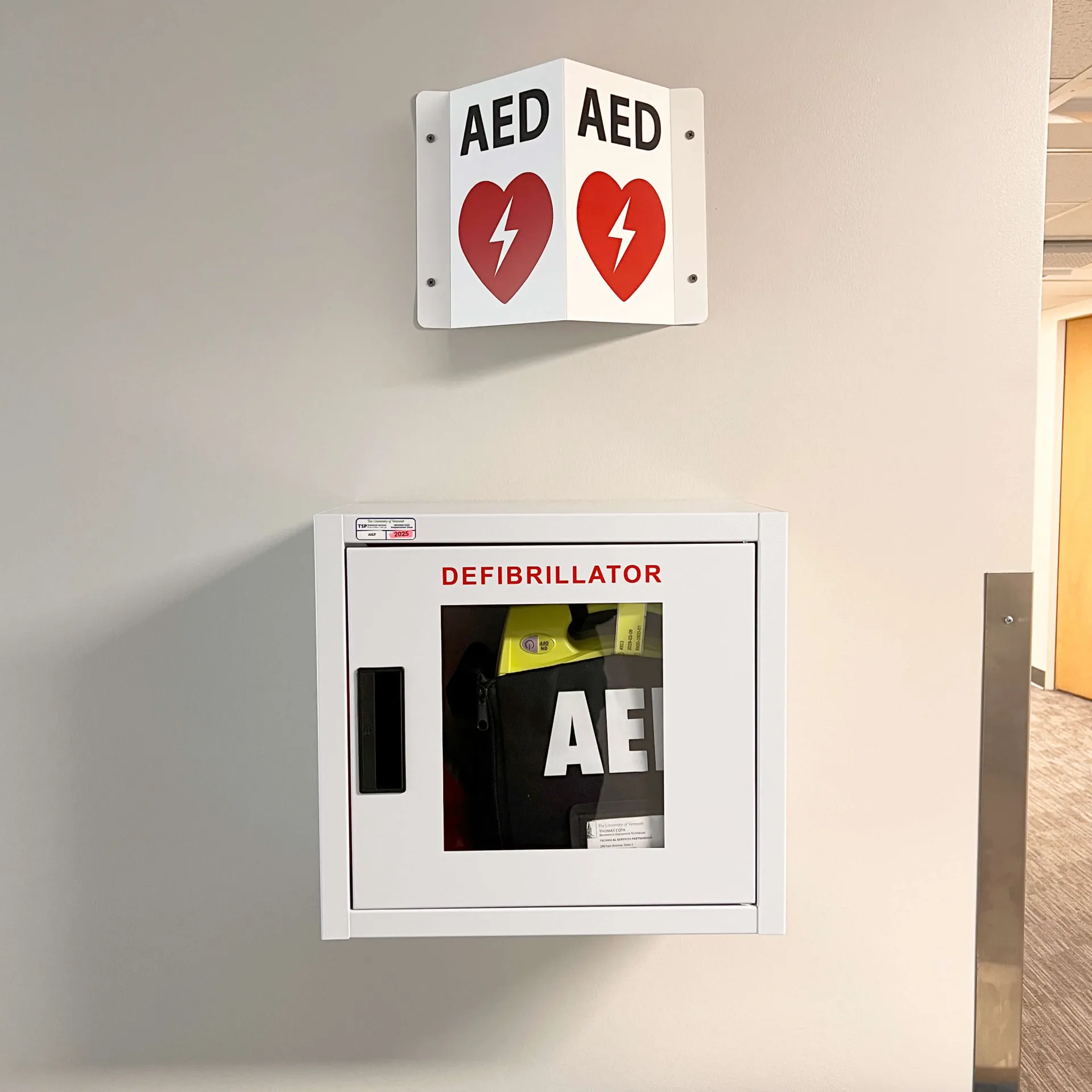 CAT ECare Station with AED mounted on a wall.