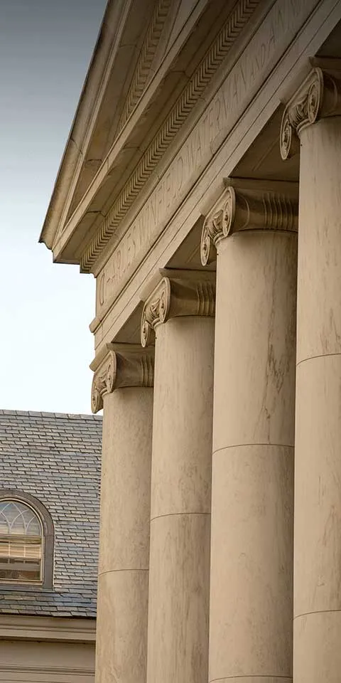 Large stone pillars in a Greek architectural style.
