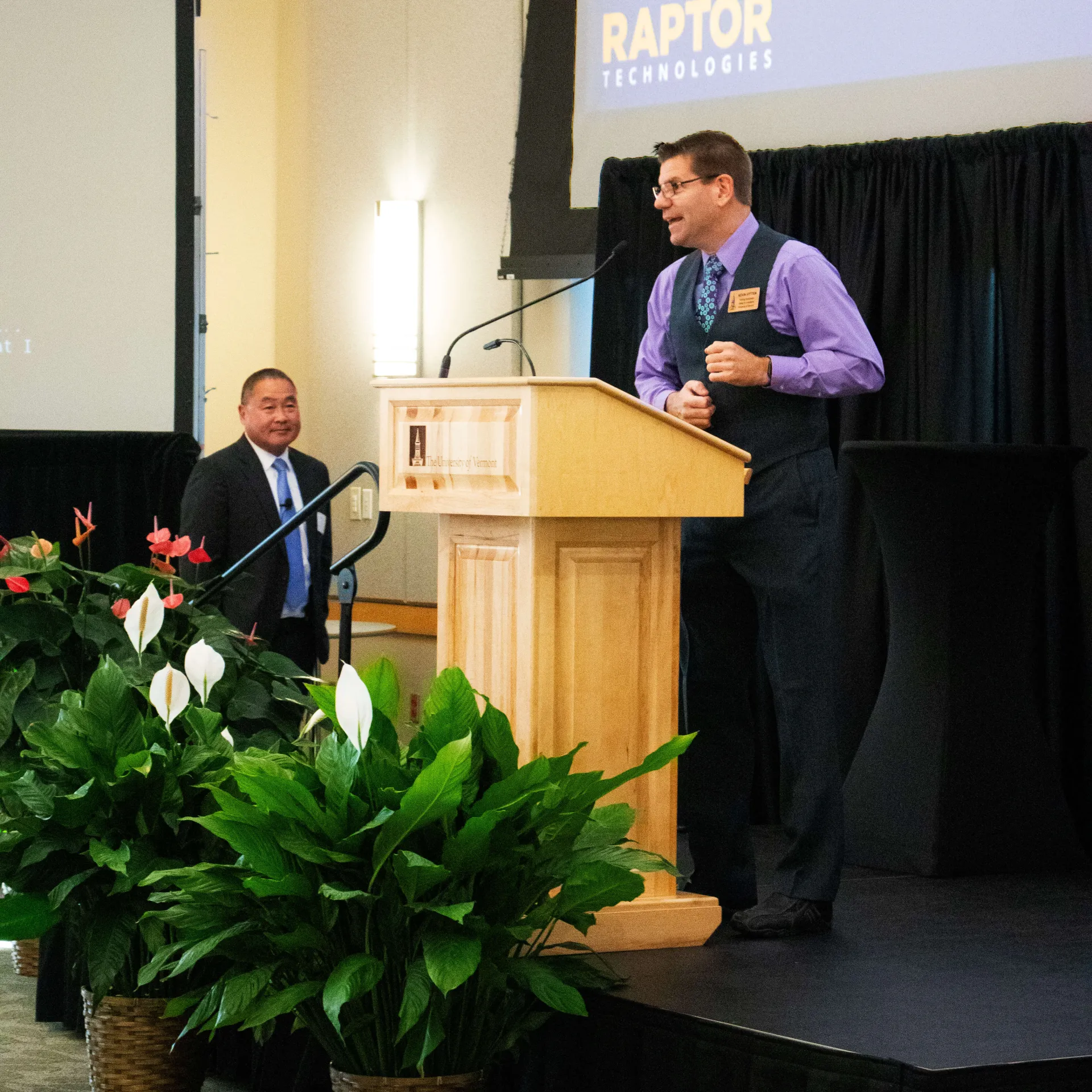 Training Coordinator introduces guest speaker on stage
