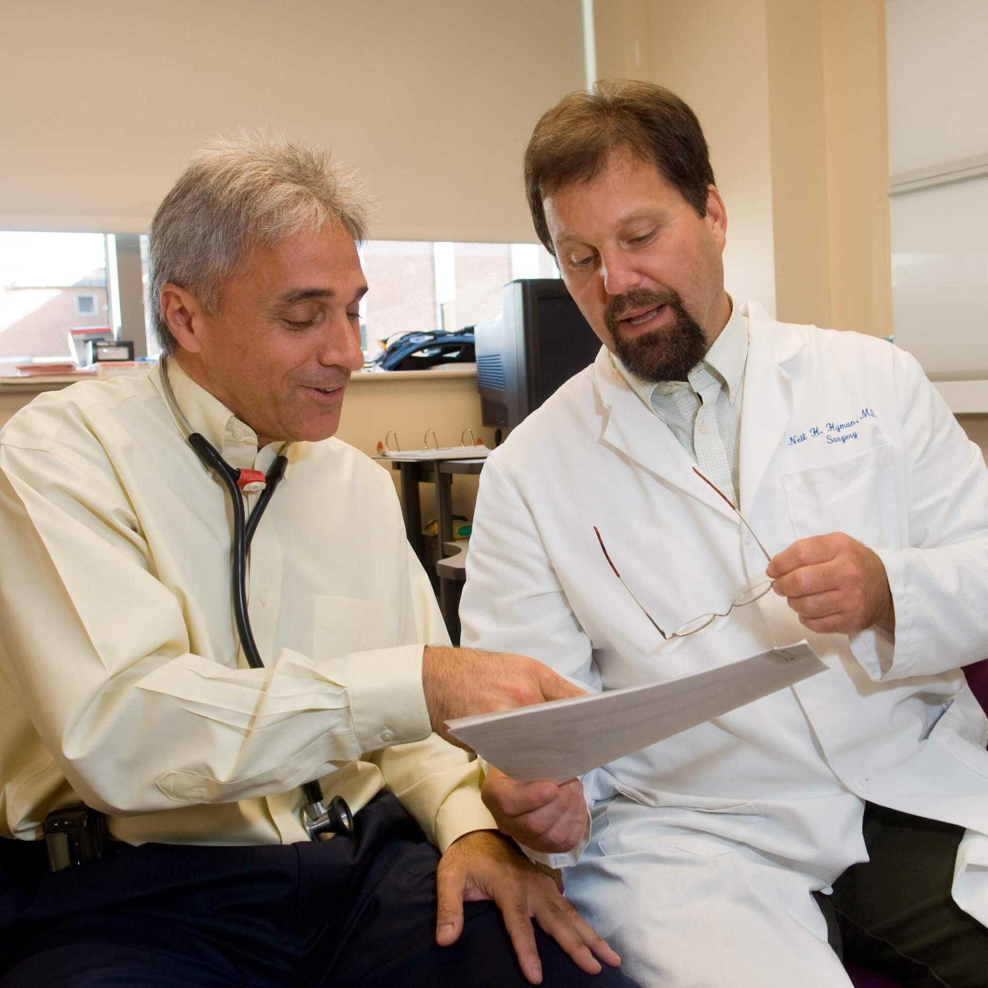 Two physicians discussing a patient file.