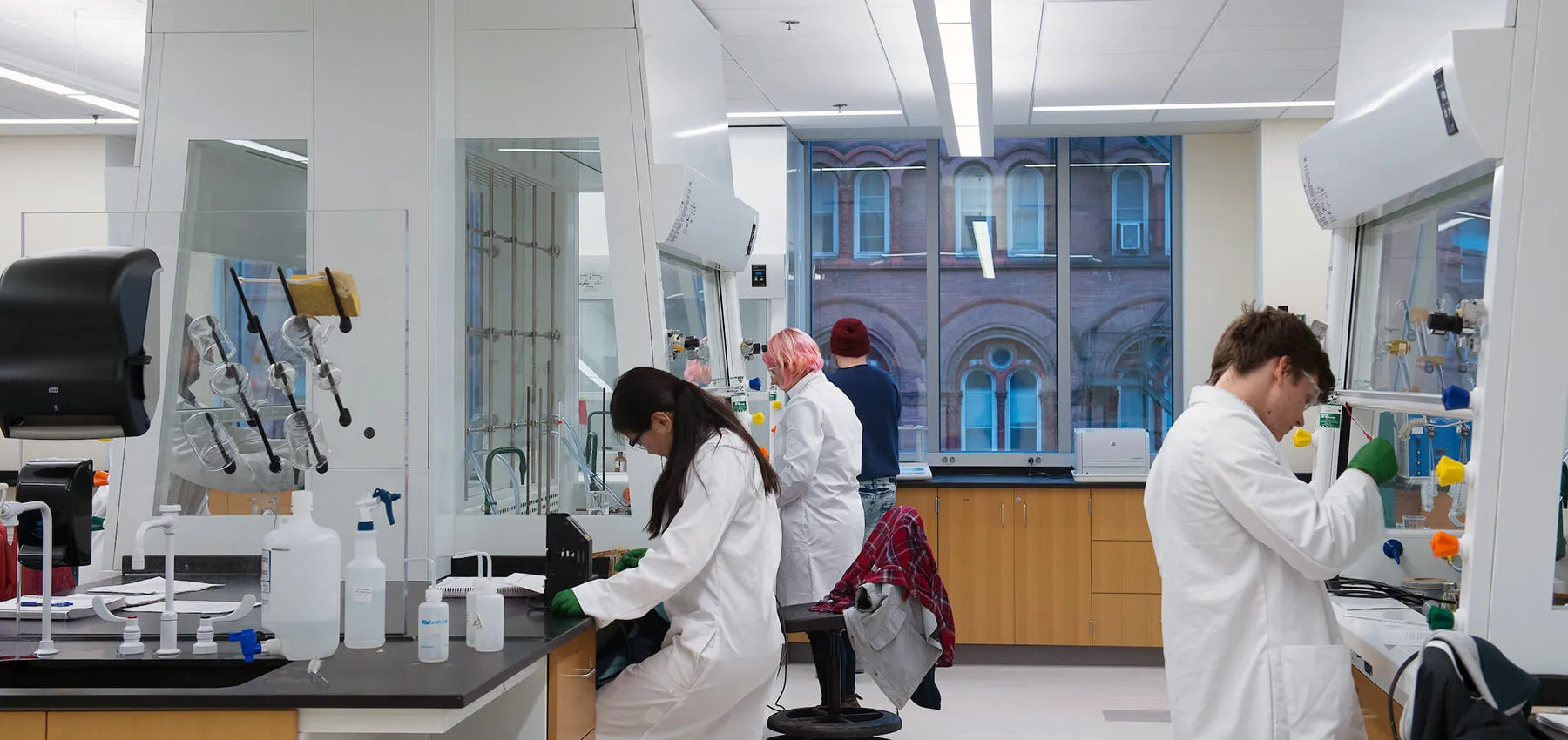 Group of student wearing white lab coat working in a chemistry lab