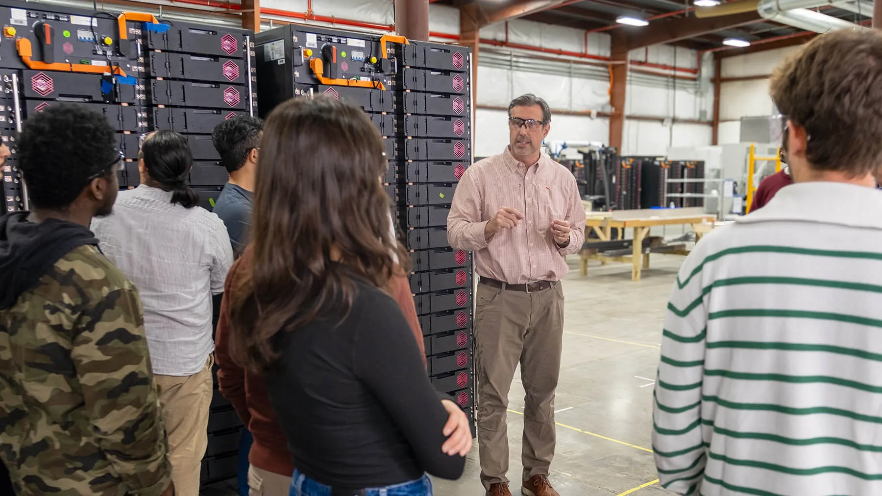 KORE President Jay Bellows guides a group of students and faculty through their manufacturing facility