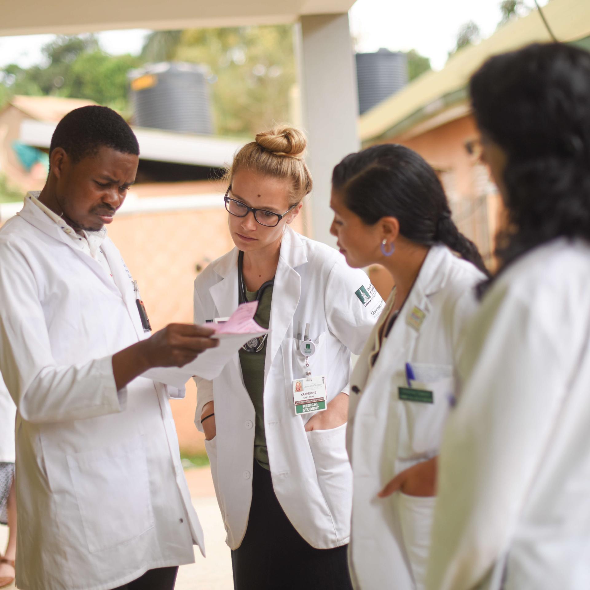 A group of fellows discussing a patient chart.