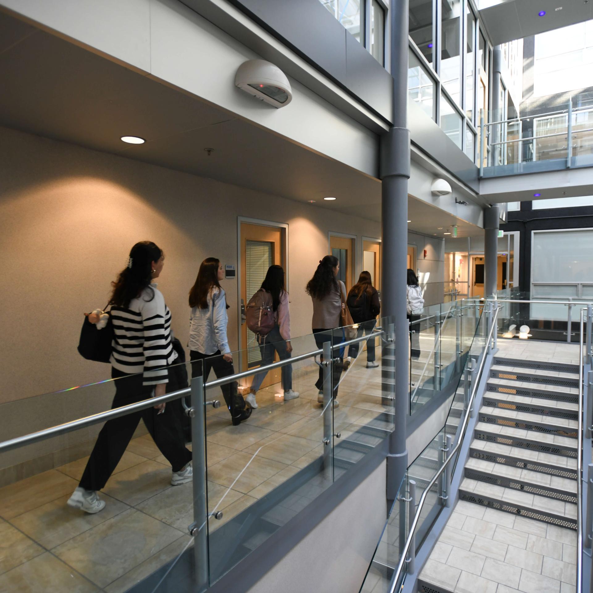 A group of students walking through the medical education building.