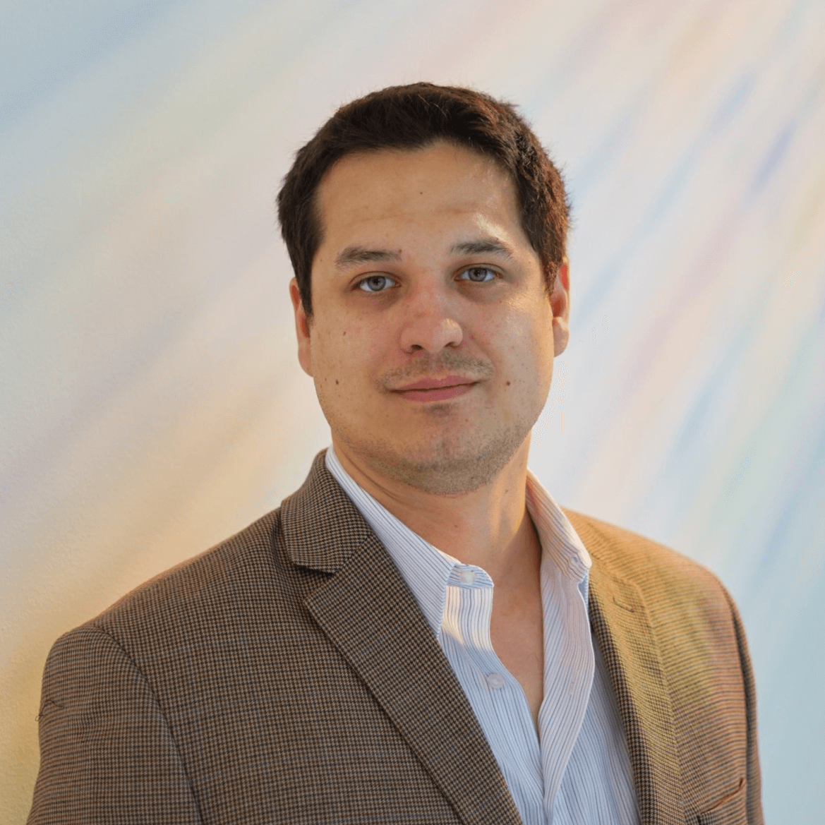 Headshot of the researcher with a blurred background.