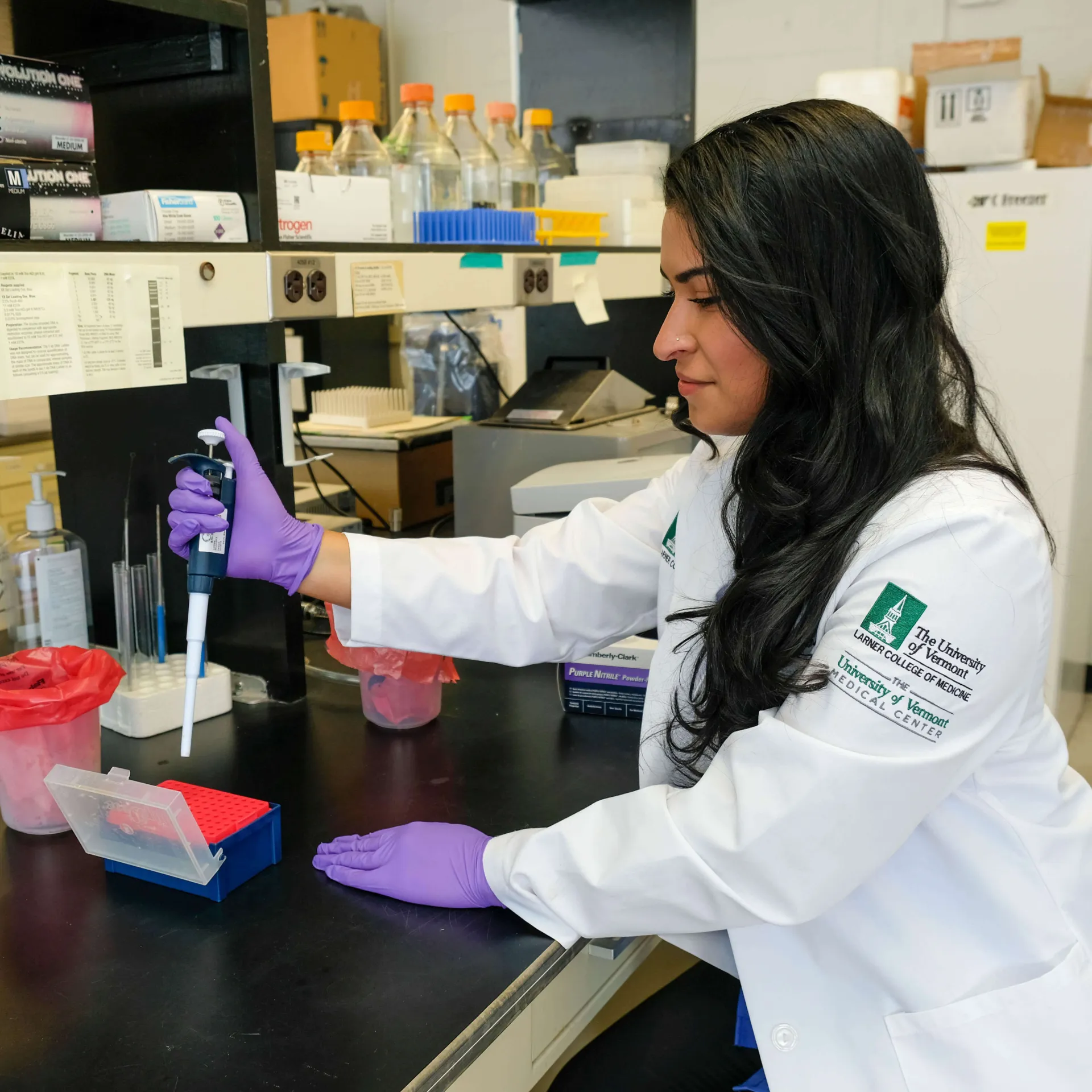 A researcher preparing a pipette for an experiment.