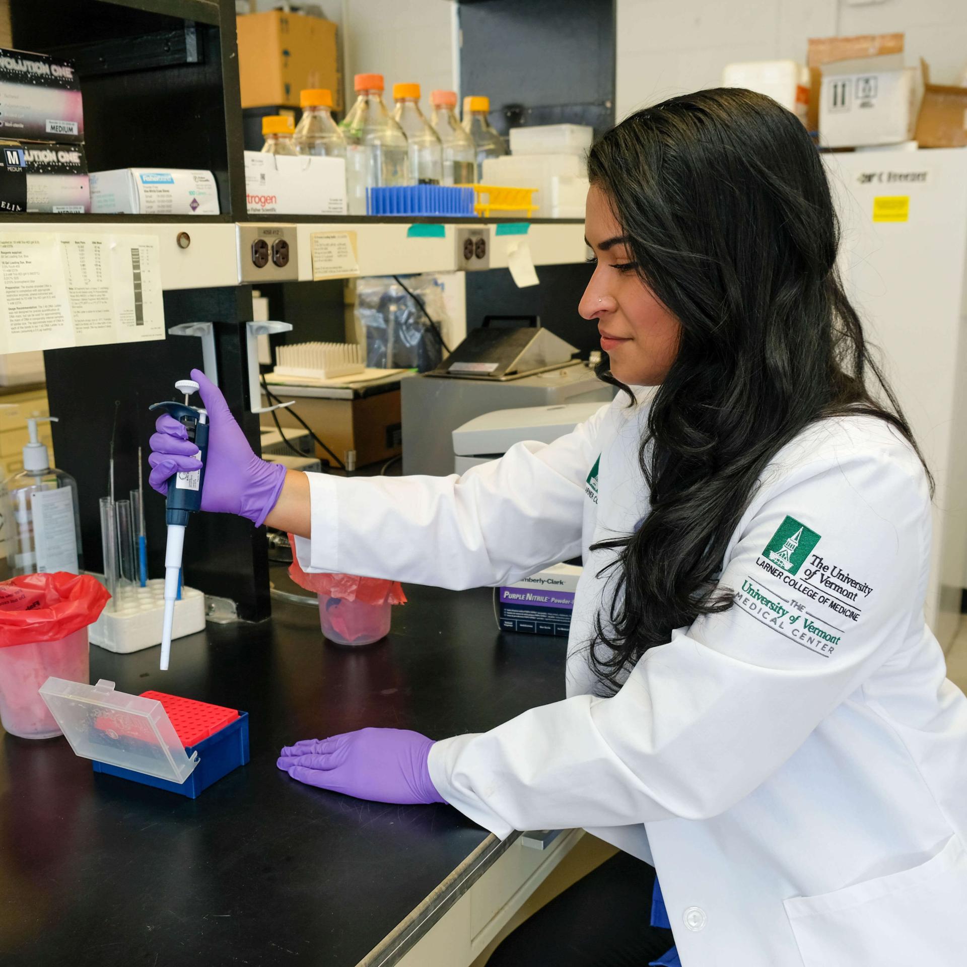 A researcher preparing a pipette for an experiment.