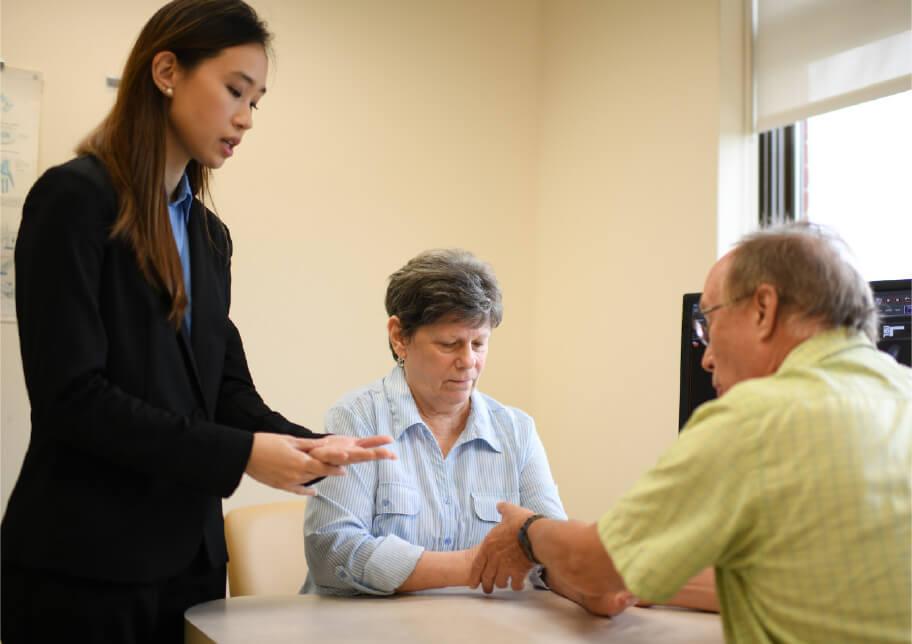 Three people looking at one's wrist function