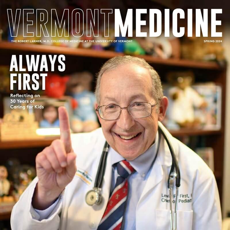 smiling doctor holding up index finger