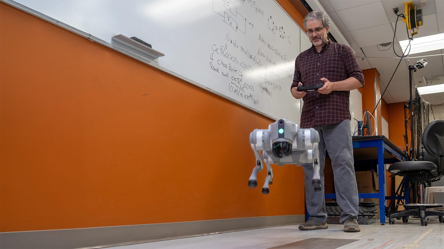 Assistant Professor Luis Duffault Espinosa demonstrates one of UVM robots
