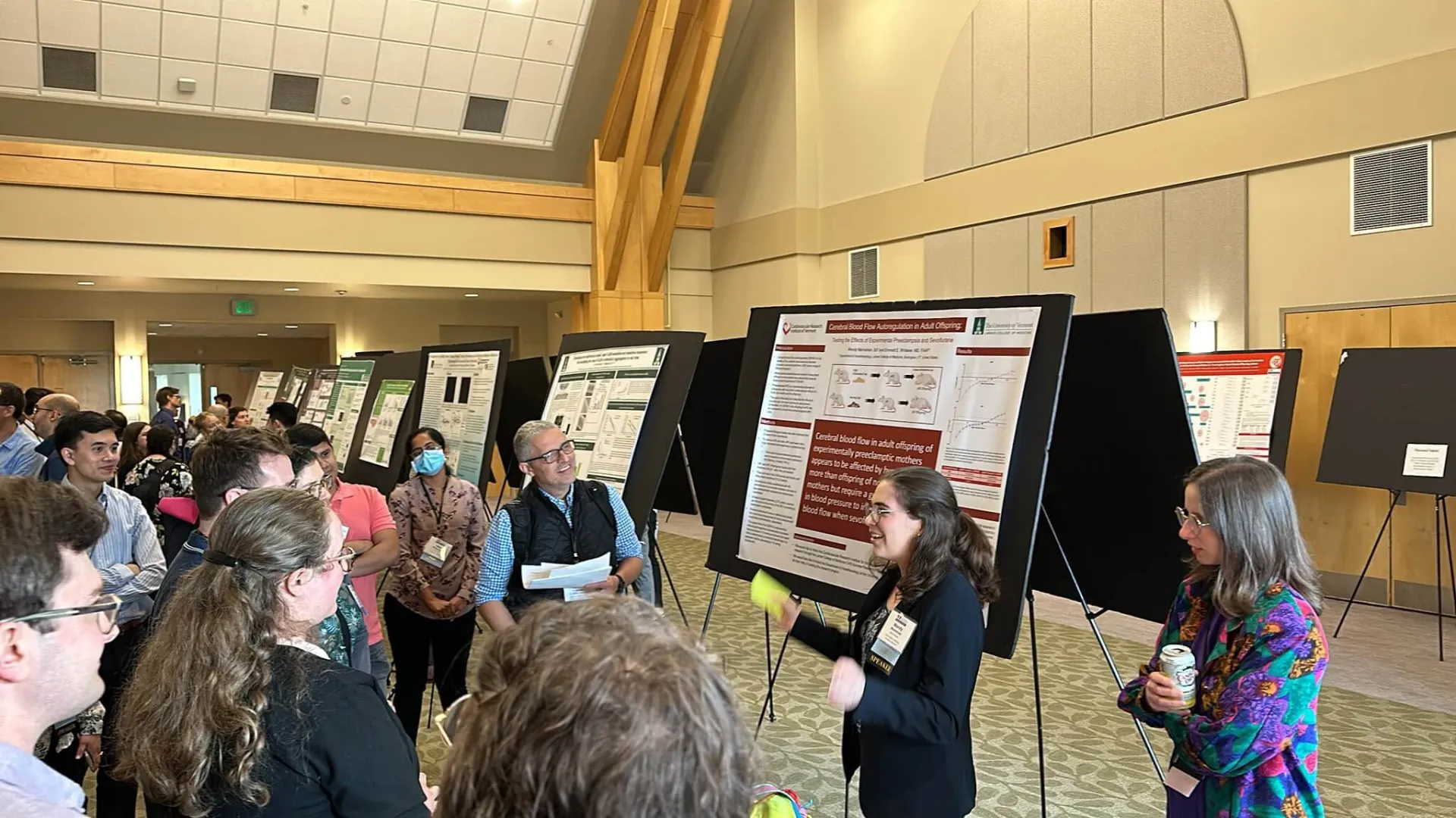 Researcher standing and presenting their findings on a large projection screen.