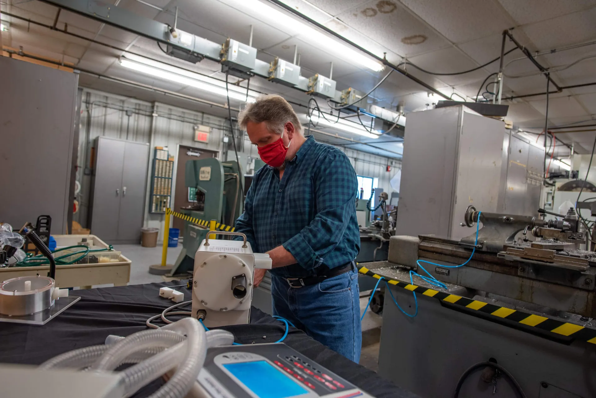 A man standing at a workbench