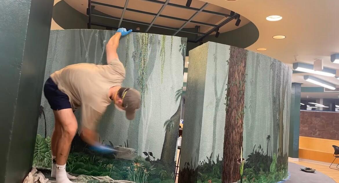 UVM intern working on mural