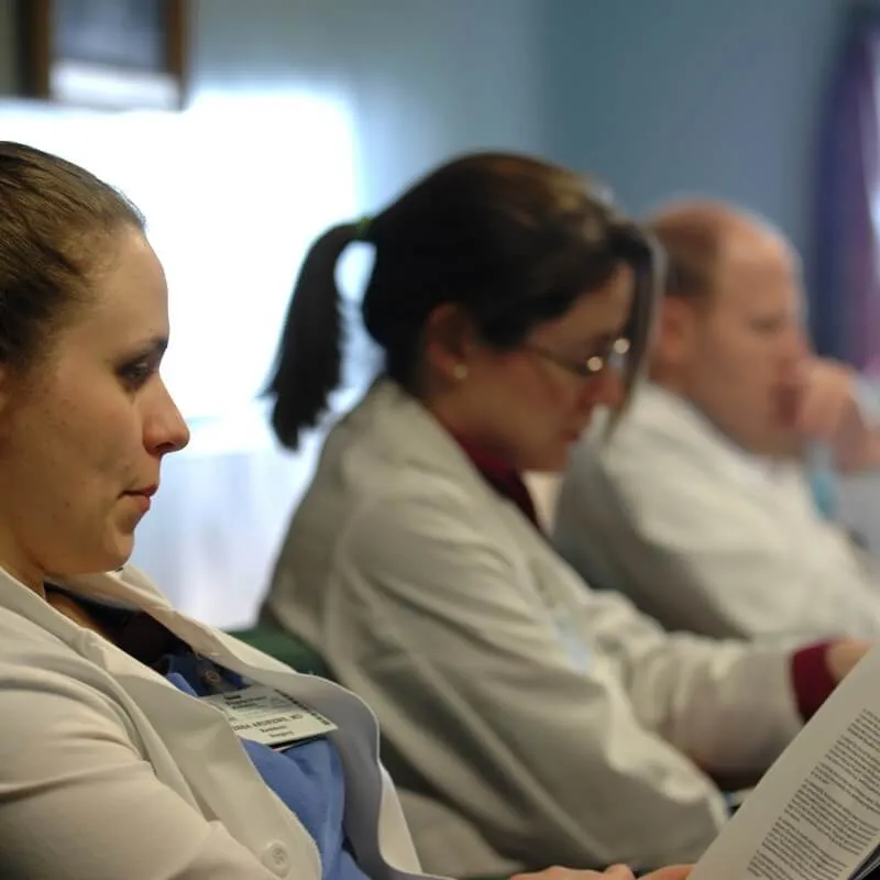 three doctors listen to a lecture