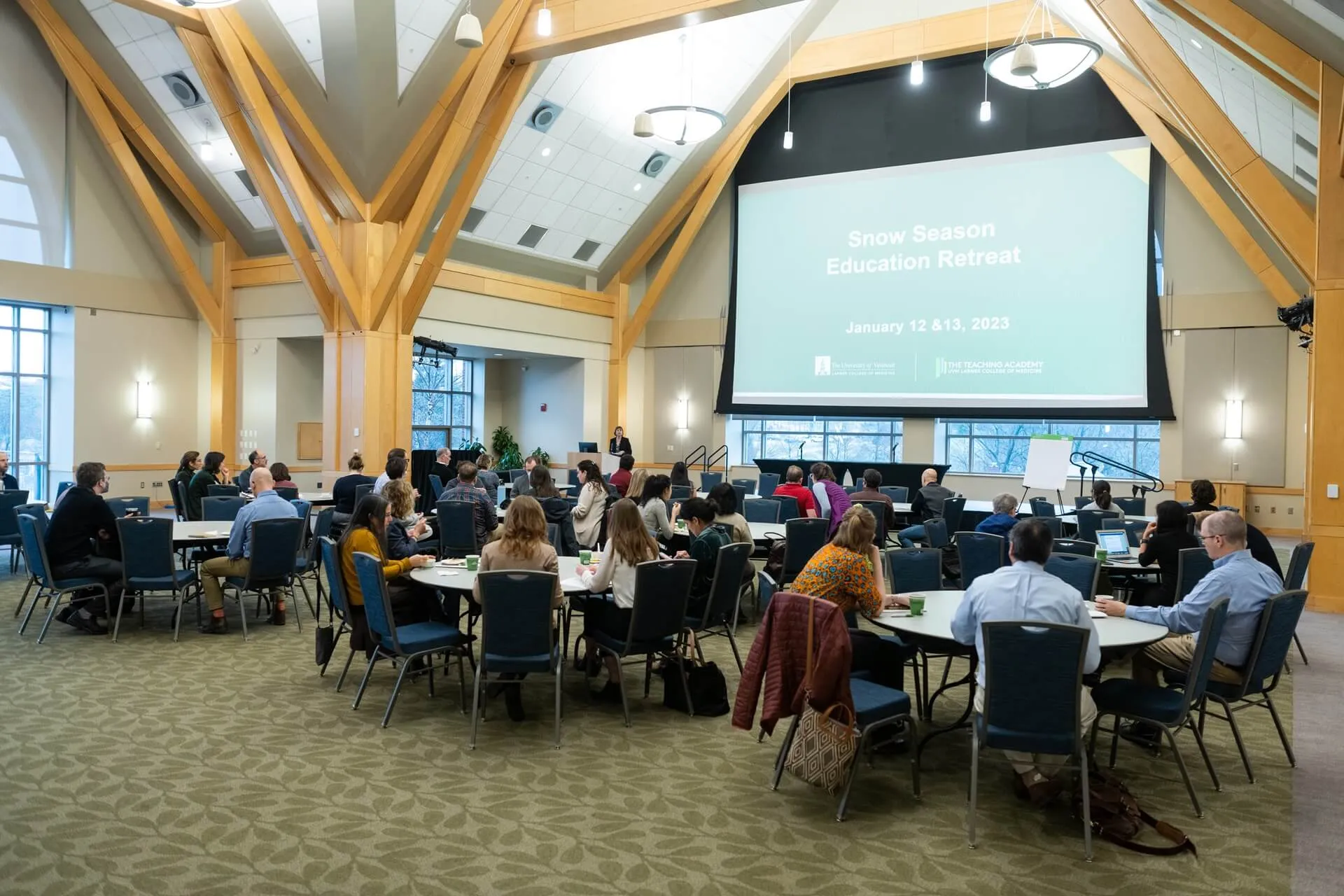 audience at tables in a large meeting room