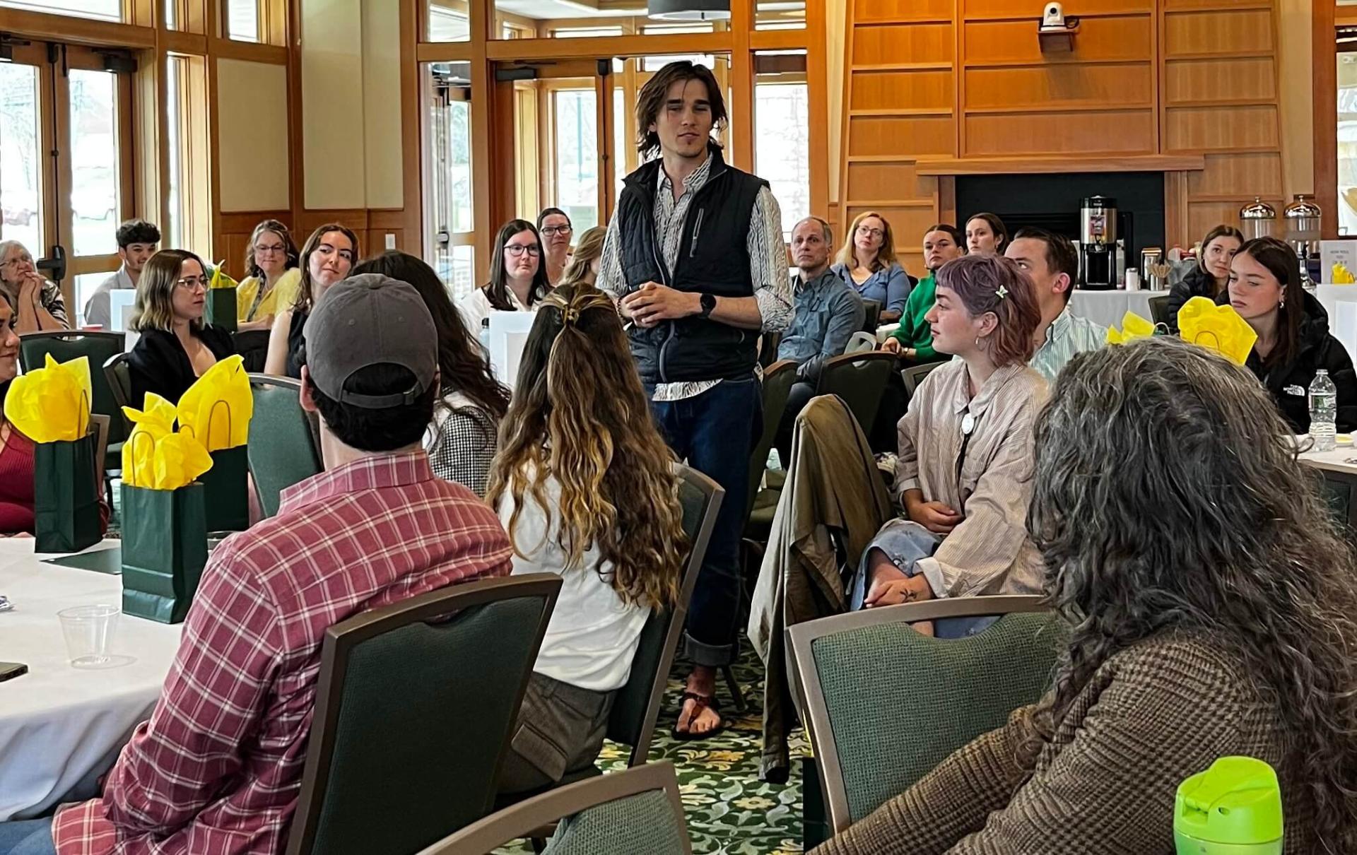 CDAE student speaking to room full of people