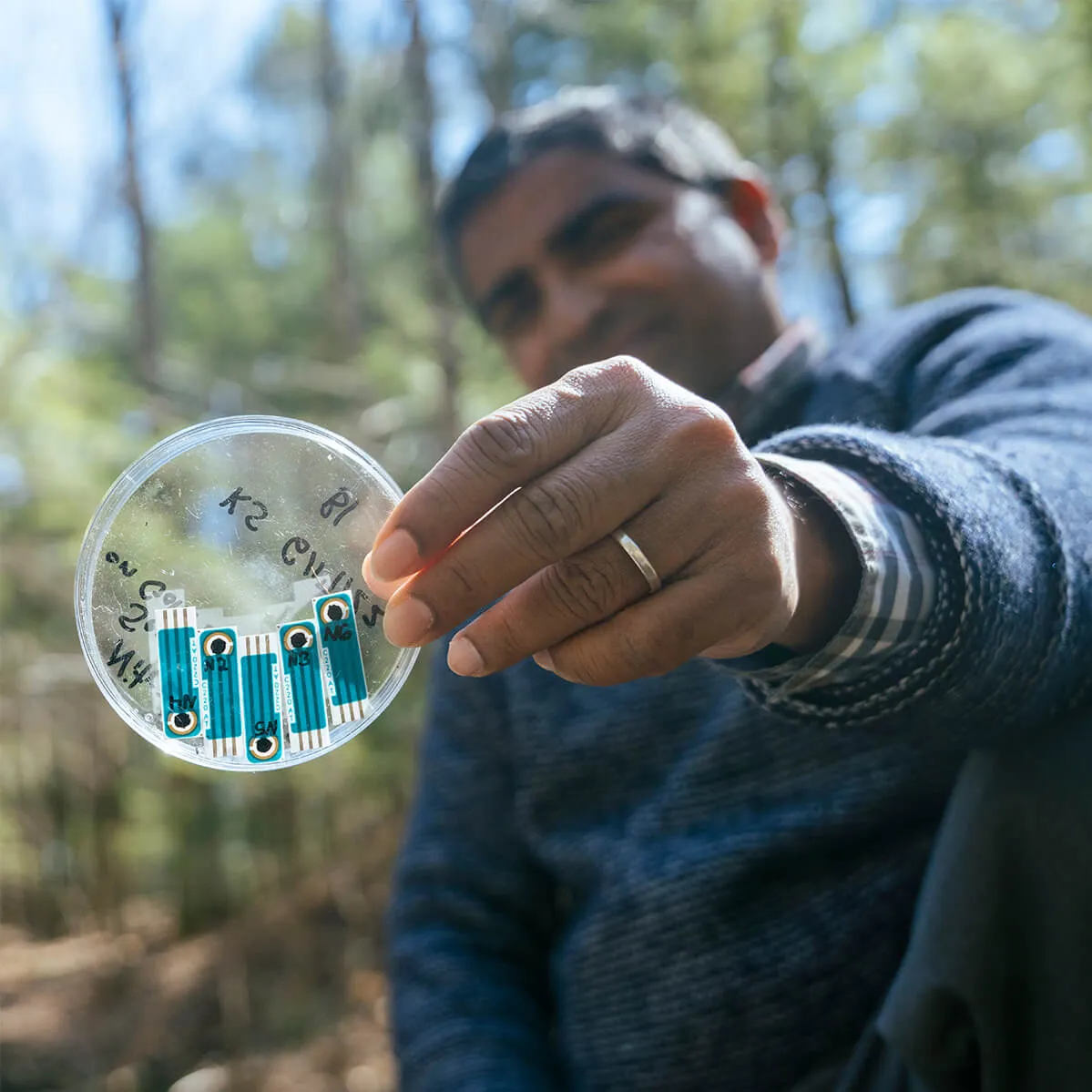 A researcher holding a petri dish