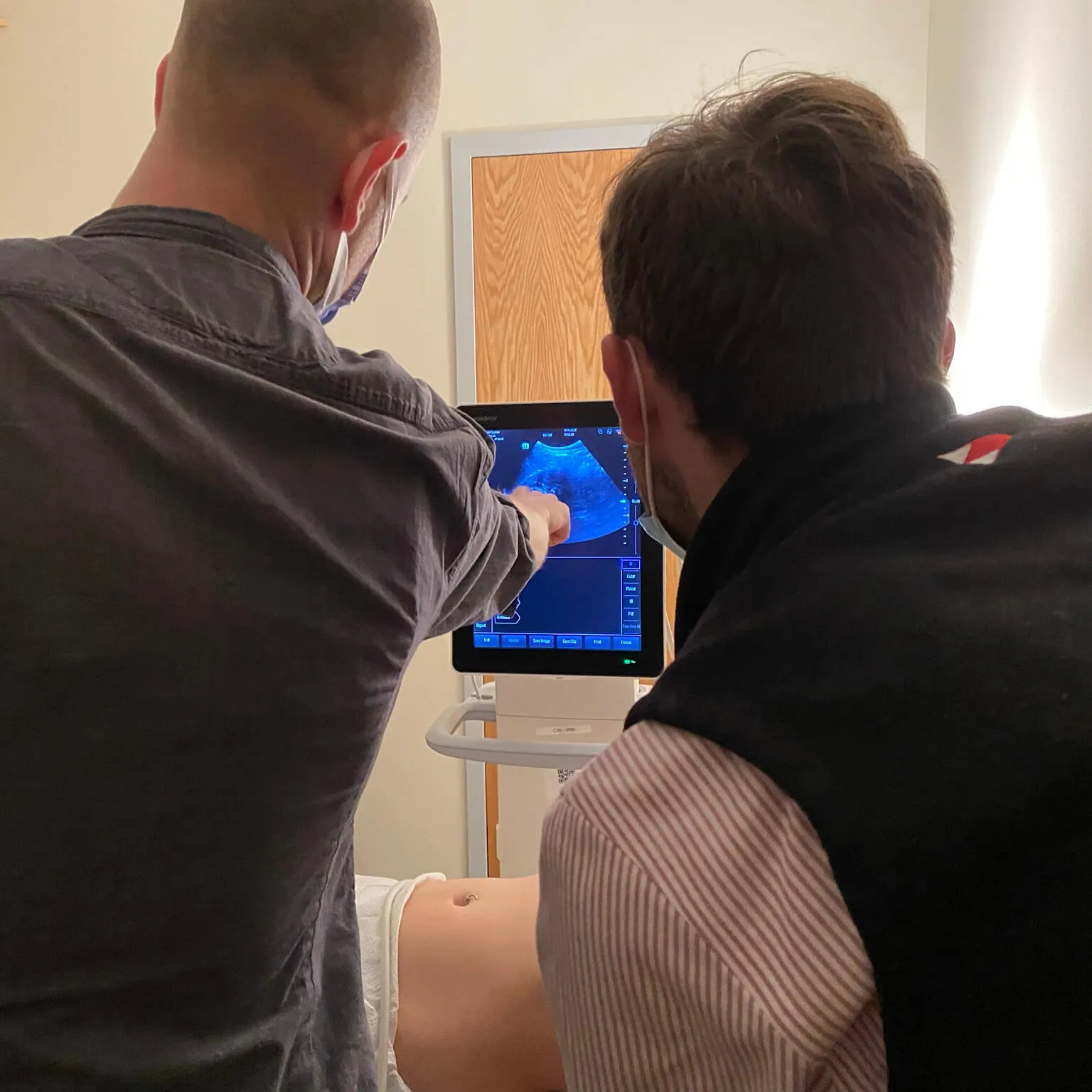 Two people looking at ultrasound imaging.