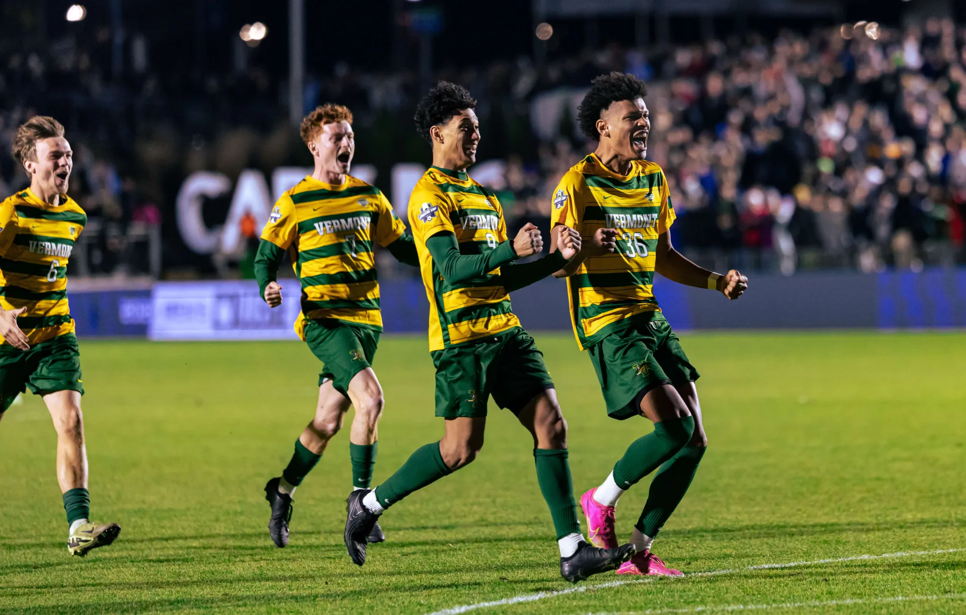 Members of the UVM men's soccer team celebrate a goal