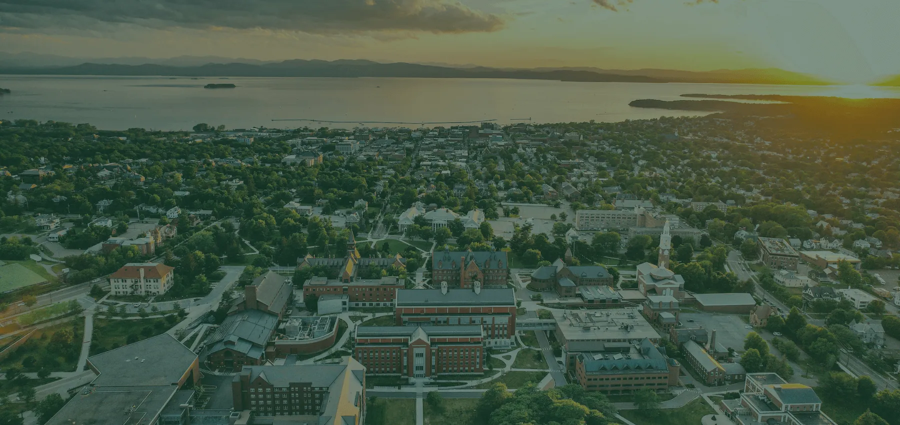 Bird's eye view of UVM campus with lake in the background