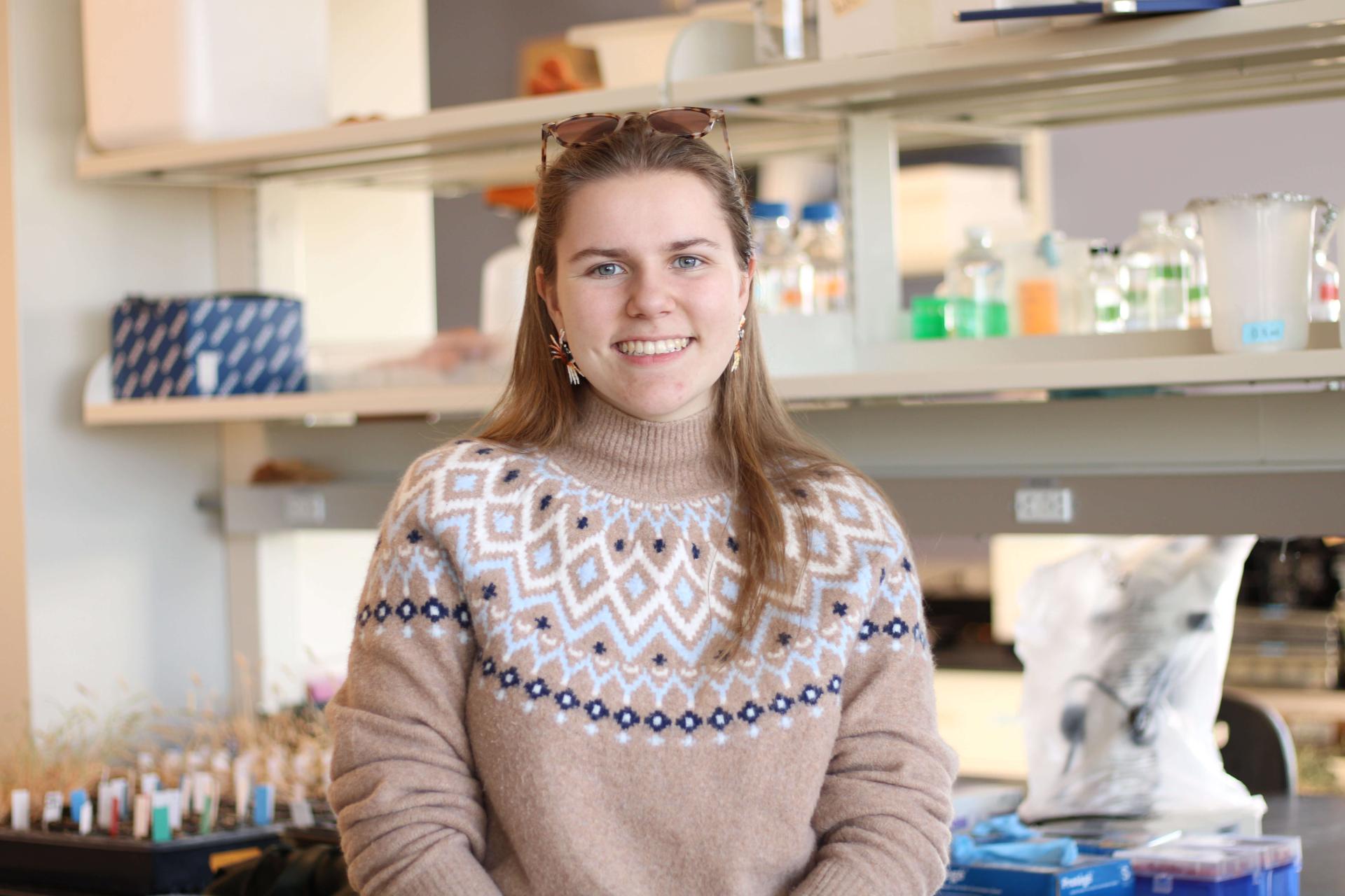 Undergraduate student in lab smiling at camera