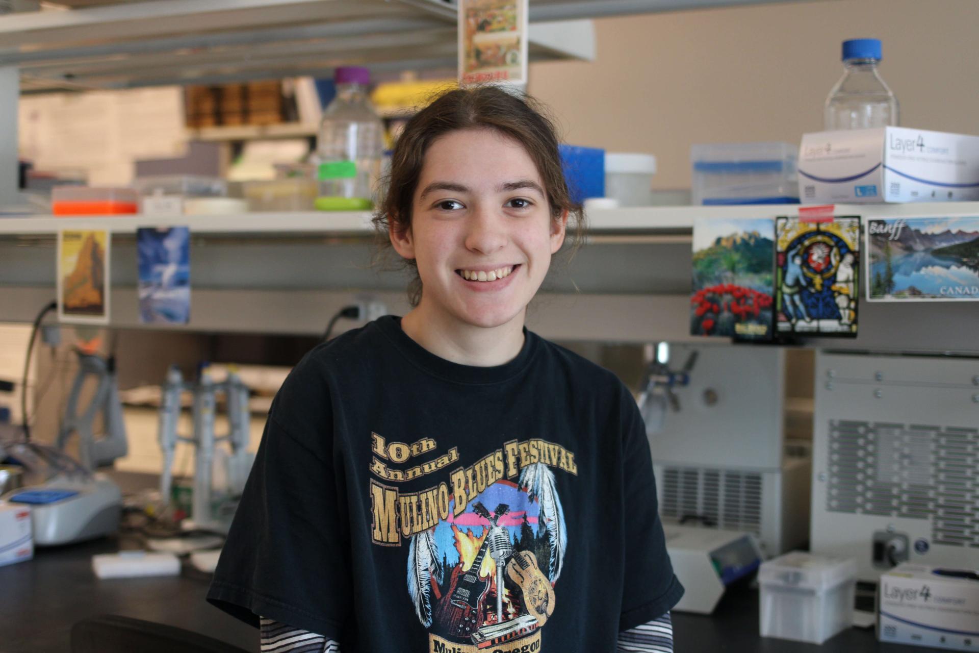 Student in Keller Lab looking at camera and smiling