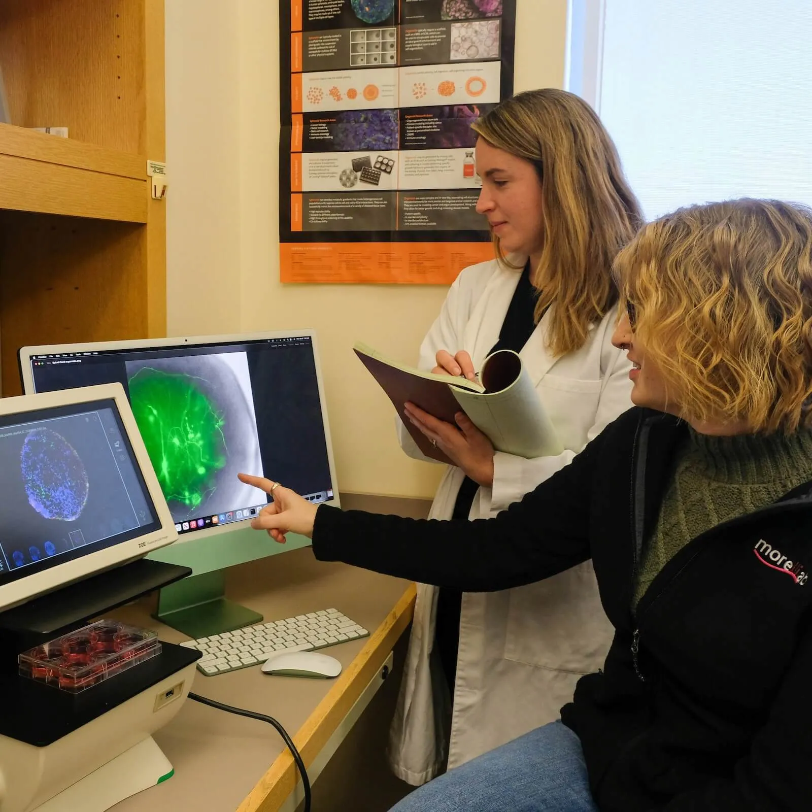 2 Scientists analyzing data on a computer.